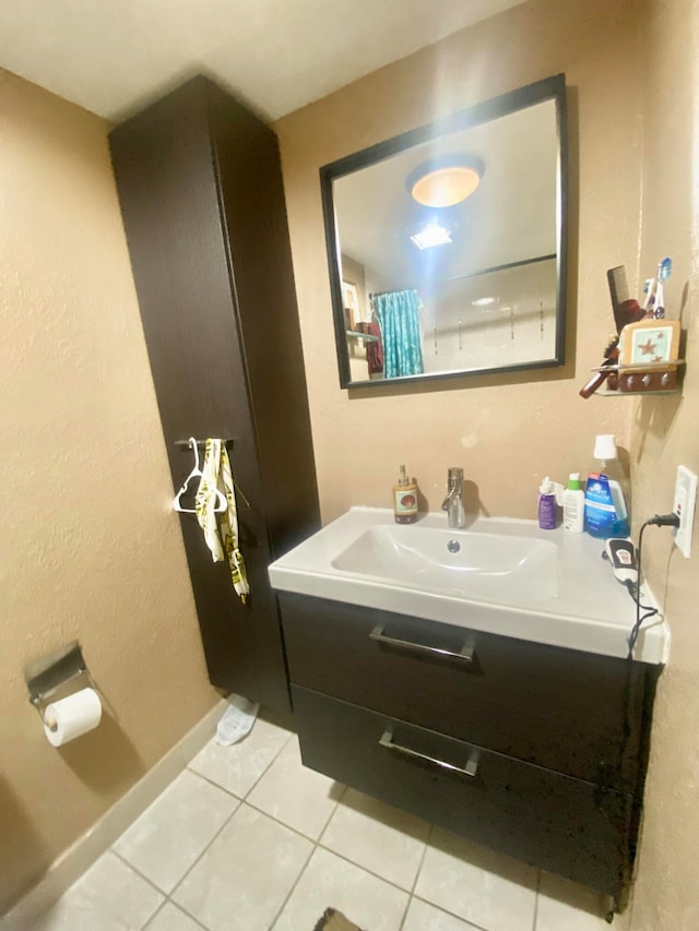 bathroom with tile floors and vanity