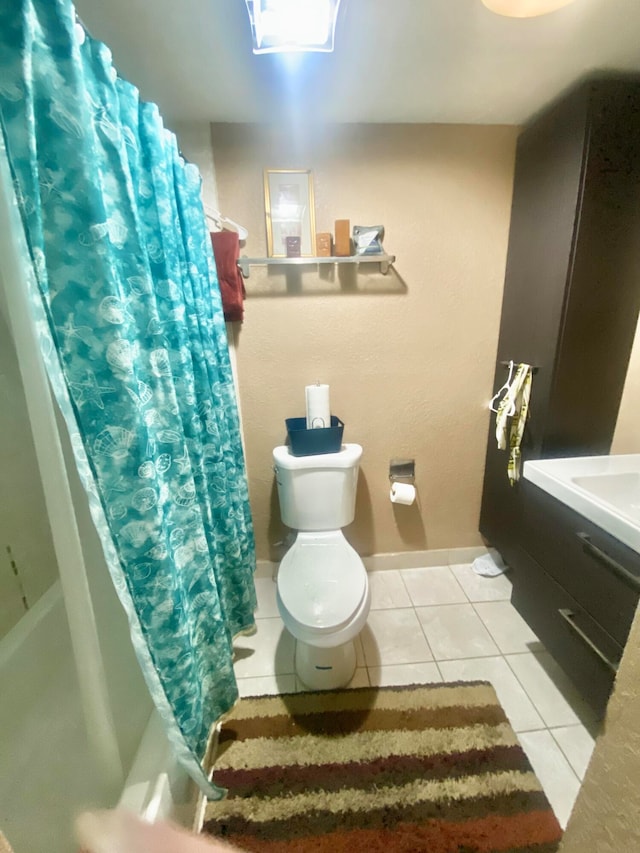 bathroom with tile floors, vanity, and toilet