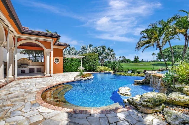 view of pool with pool water feature and a patio