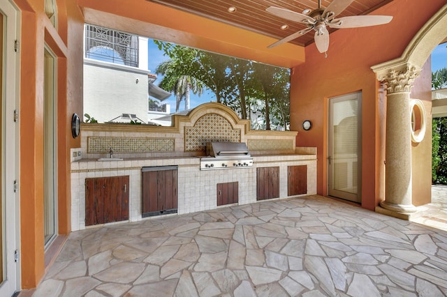 view of patio featuring area for grilling, ceiling fan, and an outdoor kitchen