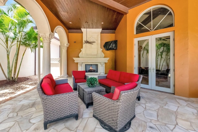 view of patio with an outdoor living space with a fireplace and french doors