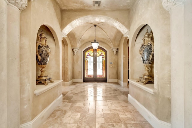 entryway featuring ornate columns and french doors