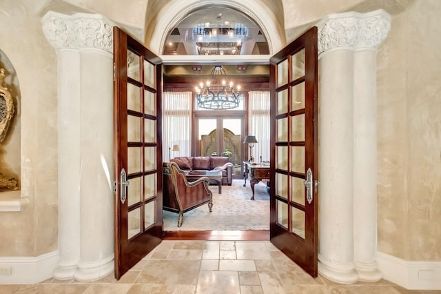 sitting room with a notable chandelier, a high ceiling, and french doors