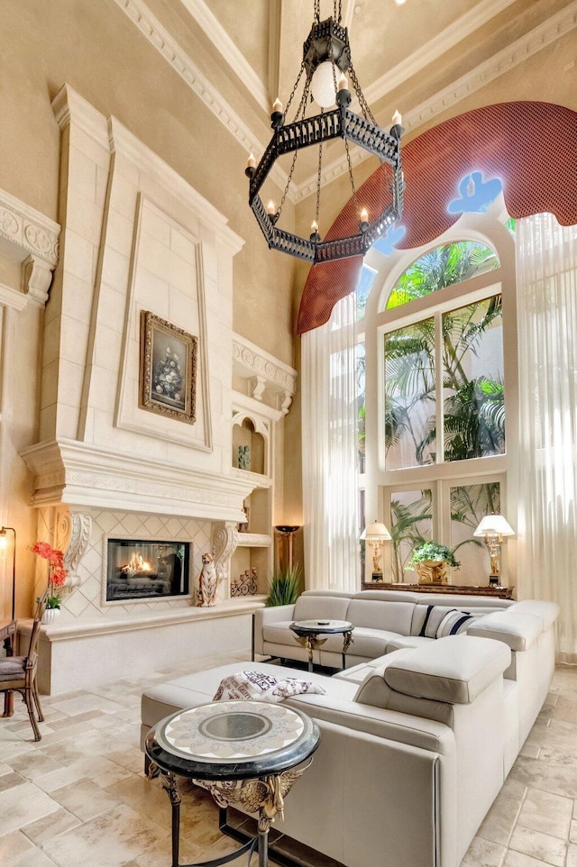 living area featuring a tiled fireplace and a high ceiling