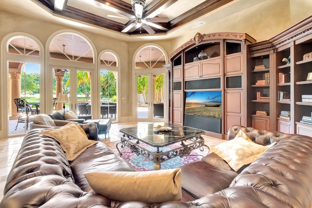 living room with coffered ceiling, french doors, crown molding, ceiling fan, and a towering ceiling