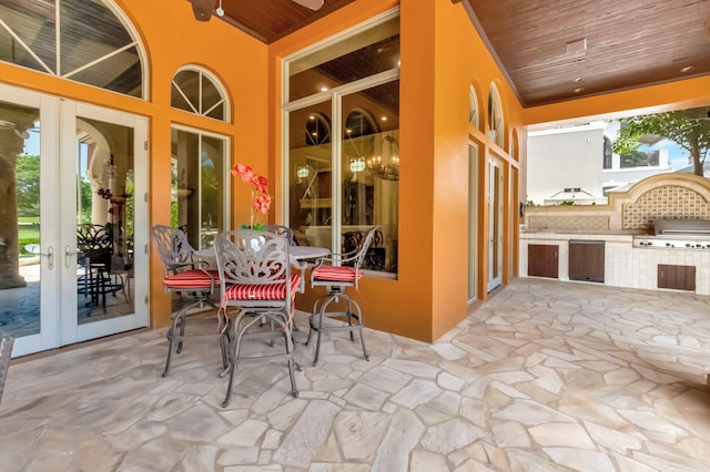 view of patio / terrace featuring french doors, grilling area, and exterior kitchen