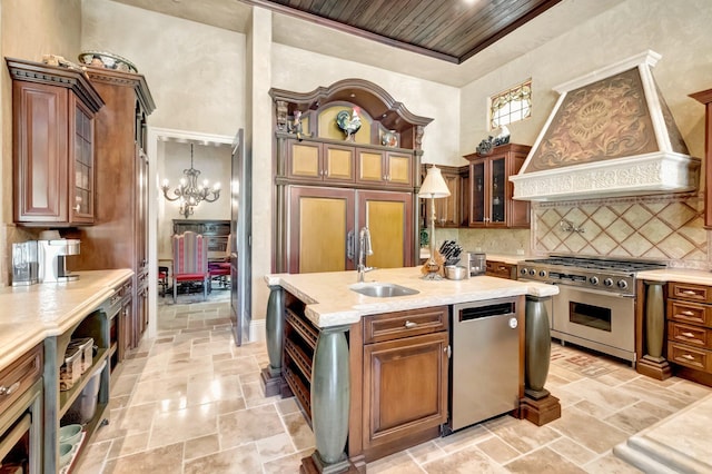 kitchen featuring sink, custom range hood, stainless steel appliances, and hanging light fixtures