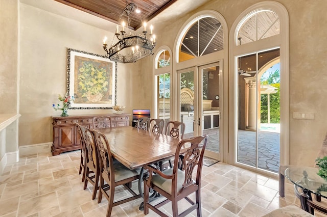 dining room featuring wooden ceiling, a high ceiling, and french doors