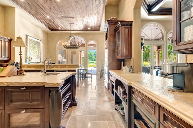 kitchen with a healthy amount of sunlight, sink, wooden ceiling, and a notable chandelier