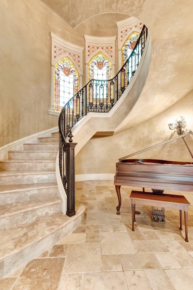 stairs featuring a high ceiling