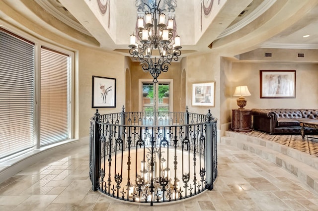 interior space with crown molding and a chandelier