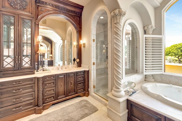 bathroom with tile patterned flooring, vanity, and separate shower and tub