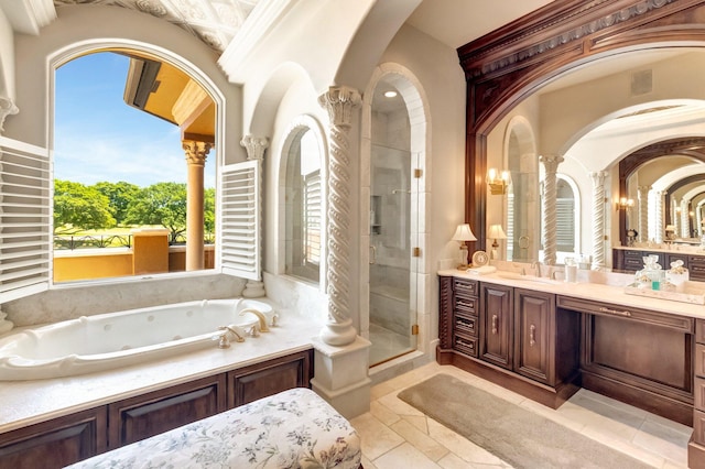 bathroom featuring shower with separate bathtub, vanity, and ornate columns