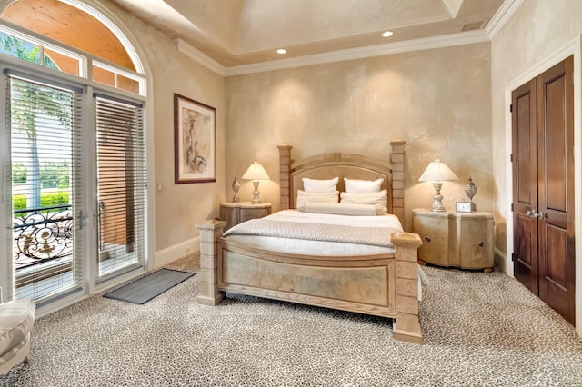 carpeted bedroom with access to exterior, a high ceiling, and ornamental molding