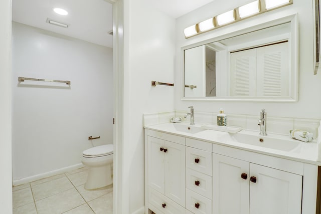 bathroom featuring tile patterned floors, vanity, and toilet