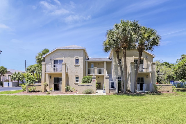 mediterranean / spanish-style house featuring a front lawn