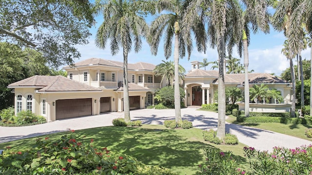 mediterranean / spanish house featuring a garage, a balcony, and a front lawn