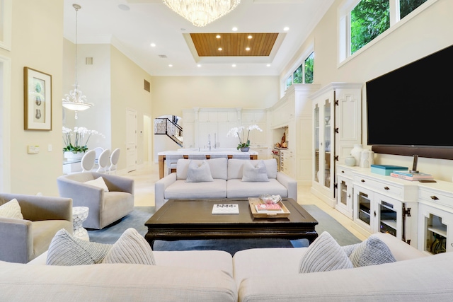 living room featuring a towering ceiling and a chandelier