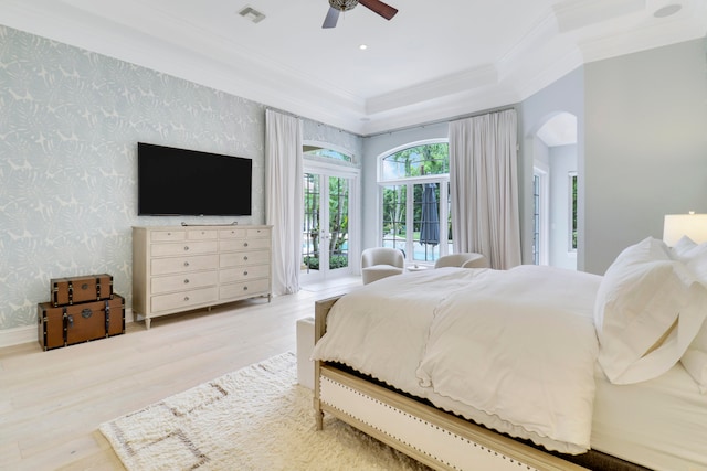 bedroom featuring access to exterior, french doors, light wood-type flooring, ceiling fan, and crown molding