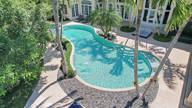 view of pool featuring french doors and a patio