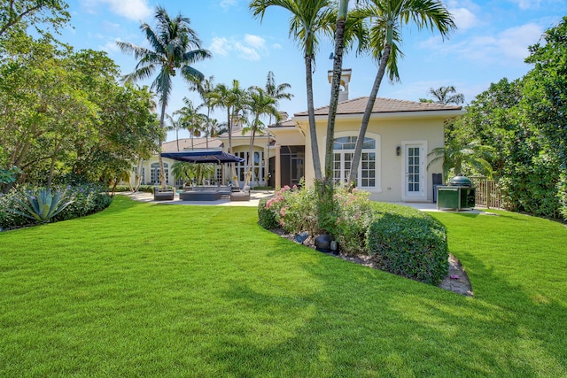 rear view of house featuring a lawn