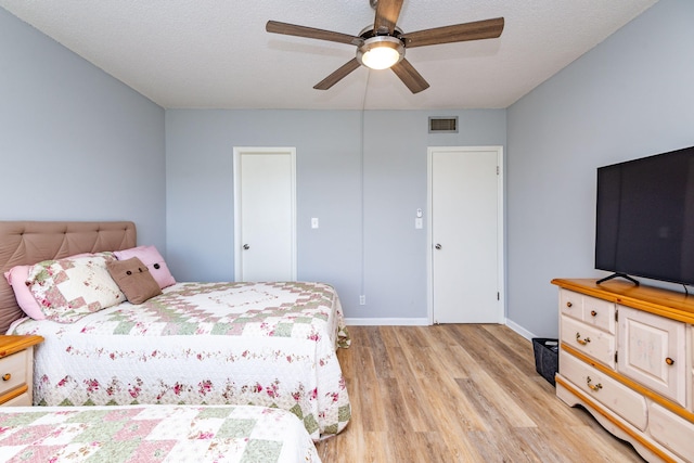 bedroom with ceiling fan and light hardwood / wood-style floors