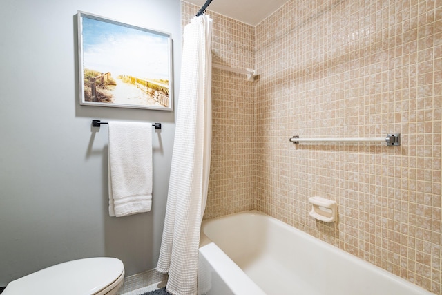 bathroom with toilet and shower / tub combo with curtain