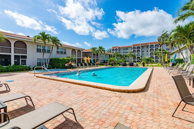 view of swimming pool with a patio