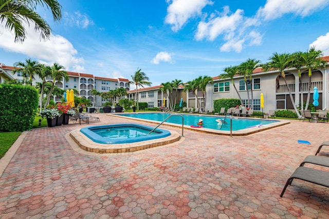 view of pool with a community hot tub and a patio