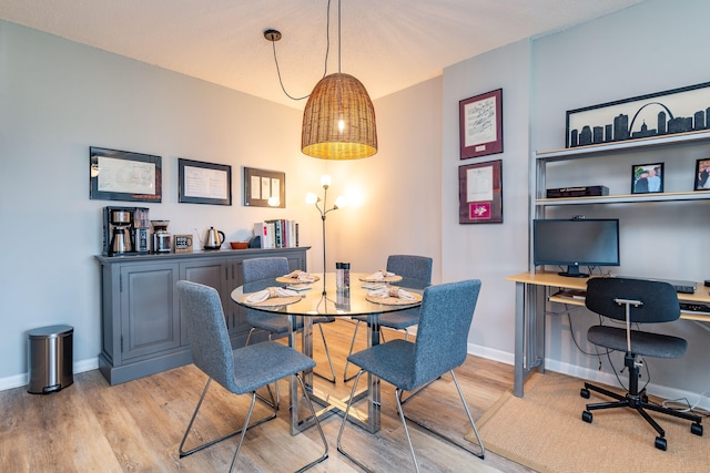 dining area featuring light wood-type flooring