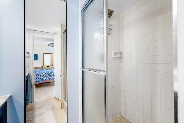 bathroom with vanity and a shower with shower door