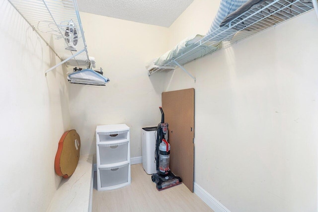 walk in closet with wood-type flooring