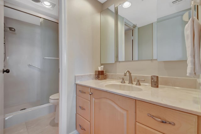 bathroom with walk in shower, tile patterned floors, vanity, and toilet