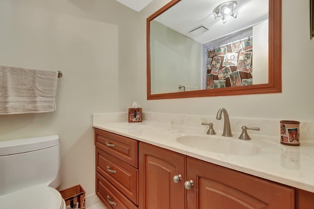 bathroom featuring vanity and toilet