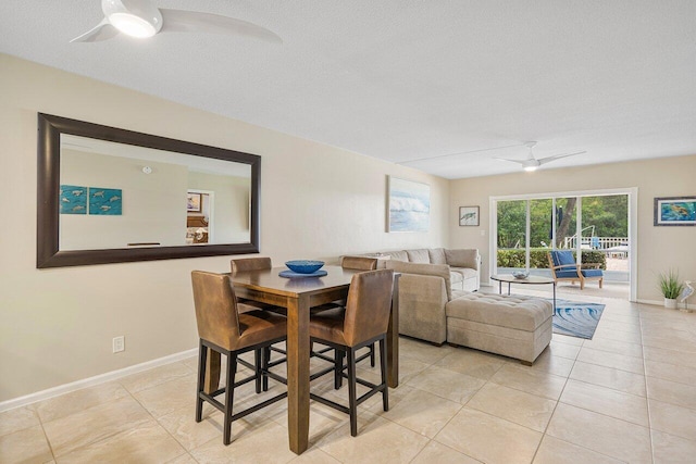 dining space with light tile patterned floors, a textured ceiling, and ceiling fan