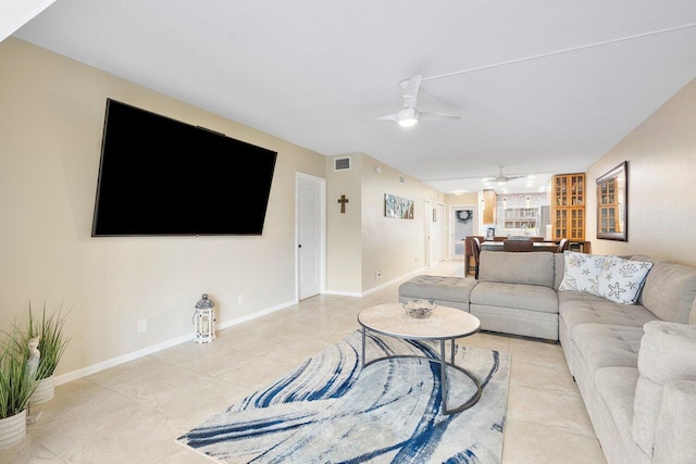 tiled living room featuring ceiling fan