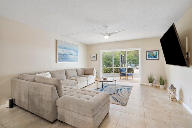 tiled living room featuring ceiling fan and a textured ceiling