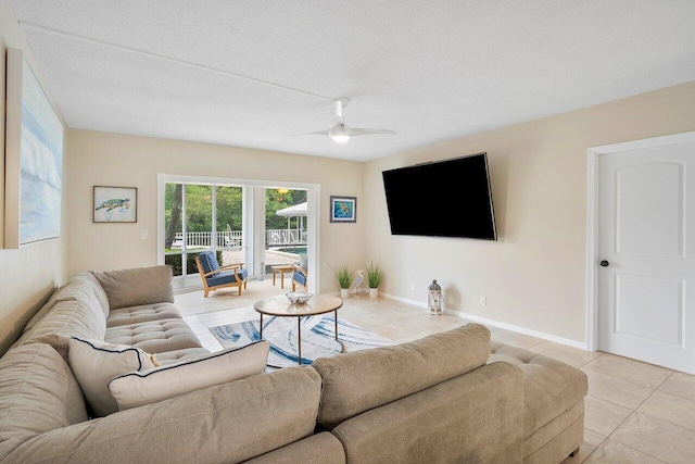 tiled living room featuring ceiling fan and a textured ceiling