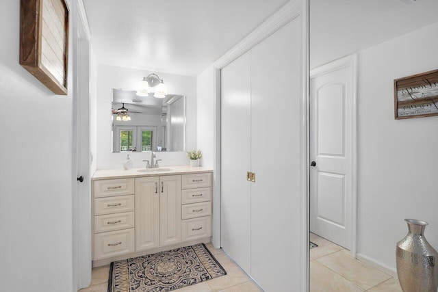 bathroom with tile patterned flooring, ceiling fan, and vanity