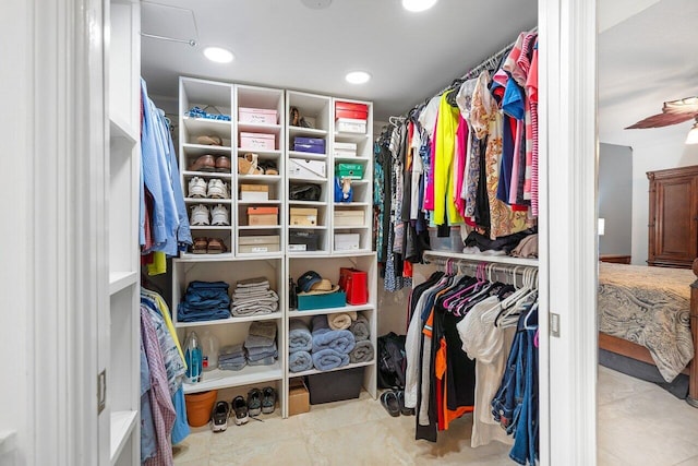 walk in closet featuring ceiling fan and light tile patterned flooring