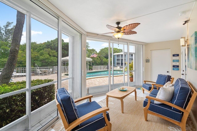 sunroom / solarium featuring ceiling fan