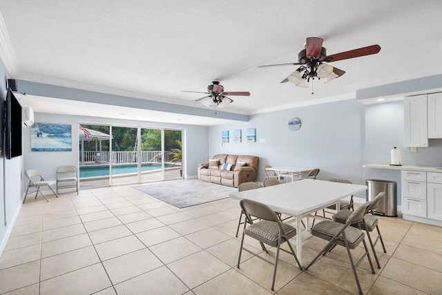 tiled dining space featuring a textured ceiling, ceiling fan, and crown molding