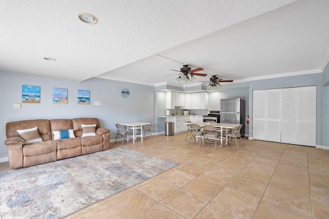 tiled living room featuring a textured ceiling, ceiling fan, and crown molding