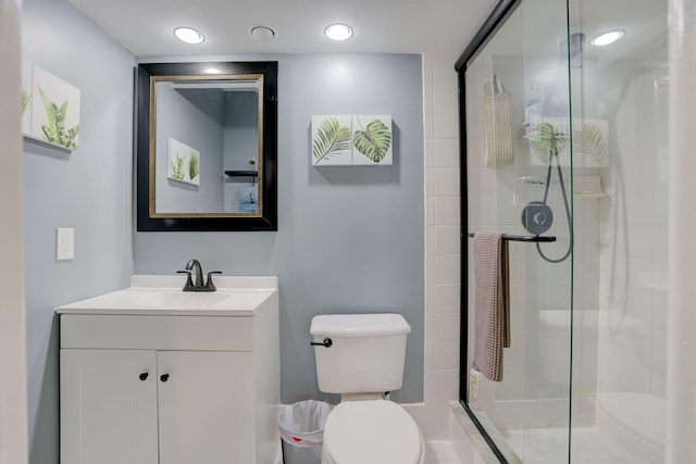 bathroom featuring walk in shower, vanity, and toilet