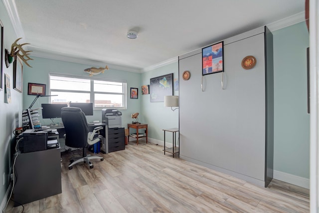 home office with light wood-type flooring and ornamental molding