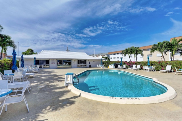 view of swimming pool featuring a patio area