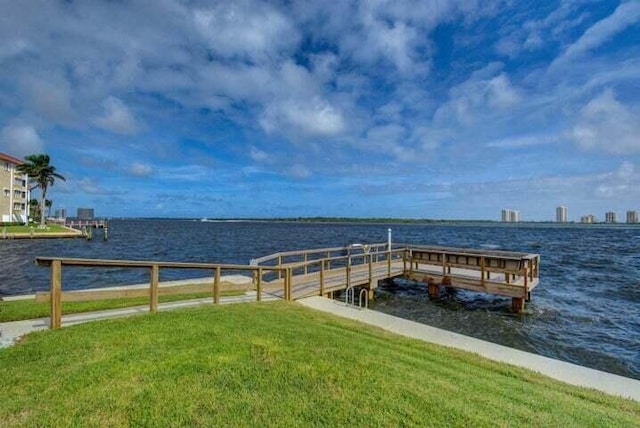 dock area with a yard and a water view