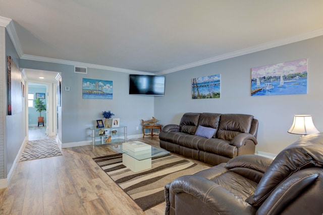 living room featuring crown molding and light wood-type flooring