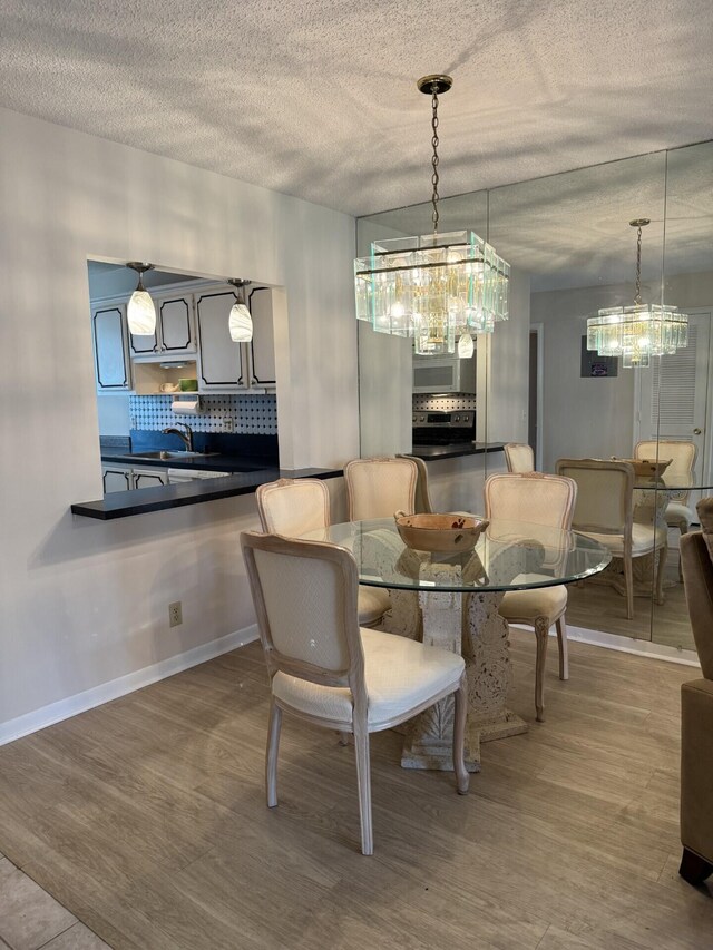 2541 Red Hibiscus Blvd Unit 31-B, Delray Beach, FL 33445 - kitchen featuring dark countertops, a sink, light tile patterned flooring, and white cabinetry