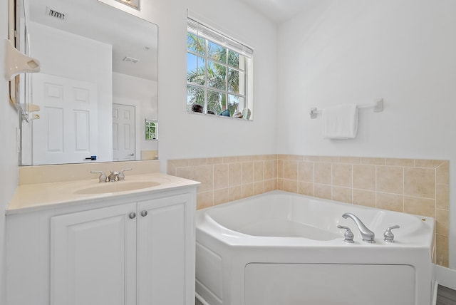 bathroom featuring a washtub and large vanity